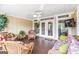 Relaxing screened-in porch featuring wicker furniture, ceiling fan, and view to backyard at 150 Campaign Trl, Fayetteville, GA 30214
