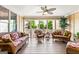 Cozy screened-in porch featuring wicker furniture, wood floors, and view to backyard at 150 Campaign Trl, Fayetteville, GA 30214