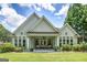 Expansive covered porch with columns overlooks a lush, green backyard at 825 Chalet Hls, Mcdonough, GA 30253