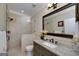This bathroom features a granite vanity, a large mirror, a walk-in shower with neutral tile, and soft lighting at 825 Chalet Hls, Mcdonough, GA 30253