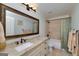 This bathroom features light blue walls, a granite countertop, and a shower-tub combination with mosaic tile at 825 Chalet Hls, Mcdonough, GA 30253
