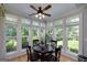 Bright breakfast nook with large windows offering views of the landscaped backyard at 825 Chalet Hls, Mcdonough, GA 30253