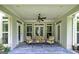 Inviting covered patio with neutral furniture and a ceiling fan for added comfort at 825 Chalet Hls, Mcdonough, GA 30253