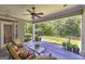 Relaxing covered patio seating area with a view of the landscaped backyard at 825 Chalet Hls, Mcdonough, GA 30253