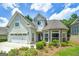 Inviting two-story home featuring a manicured lawn, stone accents, and attached two-car garage at 825 Chalet Hls, Mcdonough, GA 30253