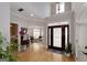 Grand foyer featuring hardwood floors, high ceilings, and a decorative front door with sidelights at 825 Chalet Hls, Mcdonough, GA 30253