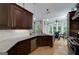 Gourmet kitchen featuring dark wood cabinets, granite countertops, and stainless steel appliances at 825 Chalet Hls, Mcdonough, GA 30253