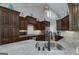 Modern kitchen with granite countertops, stainless appliances, and dark wood cabinetry with great lighting at 825 Chalet Hls, Mcdonough, GA 30253