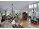 This open-concept living room combines living, dining, and kitchen areas with natural light and backyard views at 825 Chalet Hls, Mcdonough, GA 30253