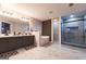 Bathroom featuring a double sink vanity, soaking tub, and glass shower at 4613 Beau Point Ct, Snellville, GA 30039