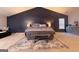 Bedroom featuring a navy accent wall, plush bed, and neutral carpet at 4613 Beau Point Ct, Snellville, GA 30039