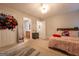 Bedroom featuring a bed with pink accents, carpeted floors, and overhead lighting at 4613 Beau Point Ct, Snellville, GA 30039