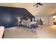 Bedroom featuring navy accent wall, a plush bed, and neutral carpet at 4613 Beau Point Ct, Snellville, GA 30039