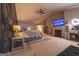 Spacious bedroom with a fireplace, TV, accent wall, and carpet at 4613 Beau Point Ct, Snellville, GA 30039