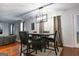 Bright dining room features hardwood floors, large window, and modern chandelier at 4613 Beau Point Ct, Snellville, GA 30039