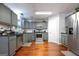Updated kitchen features gray cabinets, stainless steel appliances, hardwood floors, and ample counter space at 4613 Beau Point Ct, Snellville, GA 30039