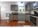 This well-lit kitchen features gray cabinets, stainless steel appliances, and a large window above the sink at 4613 Beau Point Ct, Snellville, GA 30039
