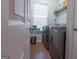 Bright laundry room with stainless steel washer and dryer, plus storage at 4613 Beau Point Ct, Snellville, GA 30039