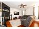 Open living room featuring a black fireplace, hardwood floors, and plush seating at 4613 Beau Point Ct, Snellville, GA 30039