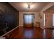 Modern living room with hardwood floors, unique wall accent, and a bright window offering natural light at 4613 Beau Point Ct, Snellville, GA 30039