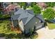 An aerial view of the rear of the home shows the roof, landscaping and attached garage at 145 Seawright Dr, Fayetteville, GA 30215