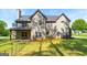 Spacious backyard with lush lawn and trees, showcasing the home's exterior features at 145 Seawright Dr, Fayetteville, GA 30215