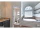 Bright bathroom featuring a tub with an arched window and a separate toilet room at 145 Seawright Dr, Fayetteville, GA 30215