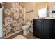 Bathroom with a dark wood vanity and cabinetry, toilet and shower featuring a patterned curtain at 145 Seawright Dr, Fayetteville, GA 30215