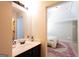 Bathroom featuring a large mirror, a vanity with sink, and doorway to bedroom at 145 Seawright Dr, Fayetteville, GA 30215