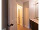 Well-lit bathroom with vanity, sink, mirror, and doorway leading to additional rooms at 145 Seawright Dr, Fayetteville, GA 30215