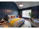 Cozy bedroom with a blue accent wall, comfortable bed, and a bright window at 145 Seawright Dr, Fayetteville, GA 30215