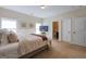 Bedroom features soft lighting, decorative pillows, and an adjoining bathroom at 145 Seawright Dr, Fayetteville, GA 30215