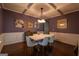 Dining room with modern table and chairs, coffered ceilings, hardwood floors and wainscotting at 145 Seawright Dr, Fayetteville, GA 30215