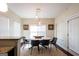 Bright dining room with modern lighting fixture, round table, and jute rug at 145 Seawright Dr, Fayetteville, GA 30215
