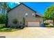 An eye-level view of the side of the home shows the roof, landscaping and attached garage at 145 Seawright Dr, Fayetteville, GA 30215