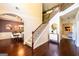 A well-lit home foyer featuring hardwood floors, an ornate stairway, and views to other rooms at 145 Seawright Dr, Fayetteville, GA 30215