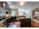 Modern kitchen featuring dark wood cabinets, stainless steel appliances, granite countertops, and hardwood flooring at 145 Seawright Dr, Fayetteville, GA 30215