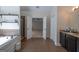 Open main bathroom featuring a soaking tub, walk-in shower, and dual vanity areas for a luxurious experience at 145 Seawright Dr, Fayetteville, GA 30215