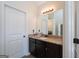 Bathroom featuring single sink vanity with granite counters, neutral wall paint, and decorative mirror at 145 Seawright Dr, Fayetteville, GA 30215