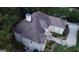 An aerial view of the roof, the driveway, the rear and the right side of the building, surrounded by green trees at 433 Abbey Springs Way, Mcdonough, GA 30253