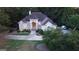 A high angle of a light beige house with a dark roof and large driveway at 433 Abbey Springs Way, Mcdonough, GA 30253