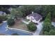 Aerial view of the home showcasing its circular driveway and manicured lawn in a lush, wooded neighborhood at 433 Abbey Springs Way, Mcdonough, GA 30253