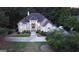 Overhead view of a large beige house with a dark roof and a circular driveway at 433 Abbey Springs Way, Mcdonough, GA 30253