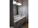 This bathroom features dual sinks, bright lighting, and granite countertops for a luxurious feel at 433 Abbey Springs Way, Mcdonough, GA 30253