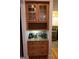 Butler pantry featuring a granite countertop, wood cabinets and decorations at 433 Abbey Springs Way, Mcdonough, GA 30253
