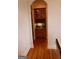 Butler pantry featuring hardwood floors and cabinets with glass fronts at 433 Abbey Springs Way, Mcdonough, GA 30253