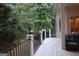 Back deck with railing, showing a view of the trees in the yard at 433 Abbey Springs Way, Mcdonough, GA 30253