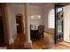 Dining room featuring an elegant chandelier, hardwood floors and large windows at 433 Abbey Springs Way, Mcdonough, GA 30253