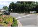 Community entrance with manicured landscaping and a turning vehicle at 433 Abbey Springs Way, Mcdonough, GA 30253