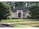 Charming home with a manicured lawn and mature trees, showcasing its inviting curb appeal at 433 Abbey Springs Way, Mcdonough, GA 30253